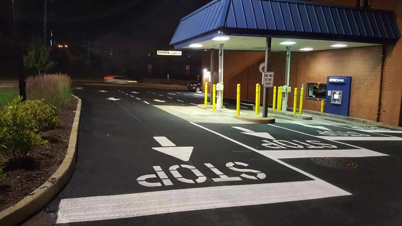 A stop sign is painted on the side of the road