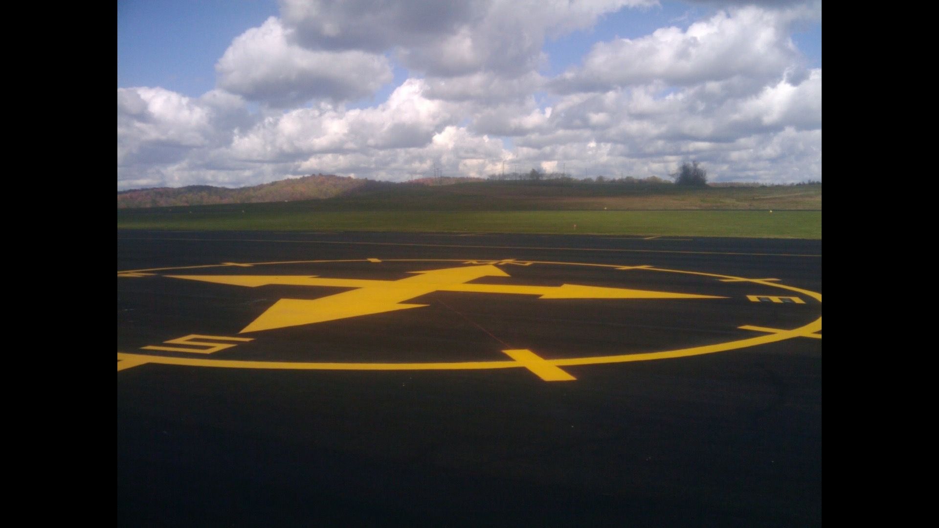 A runway with a yellow arrow pointing to the right