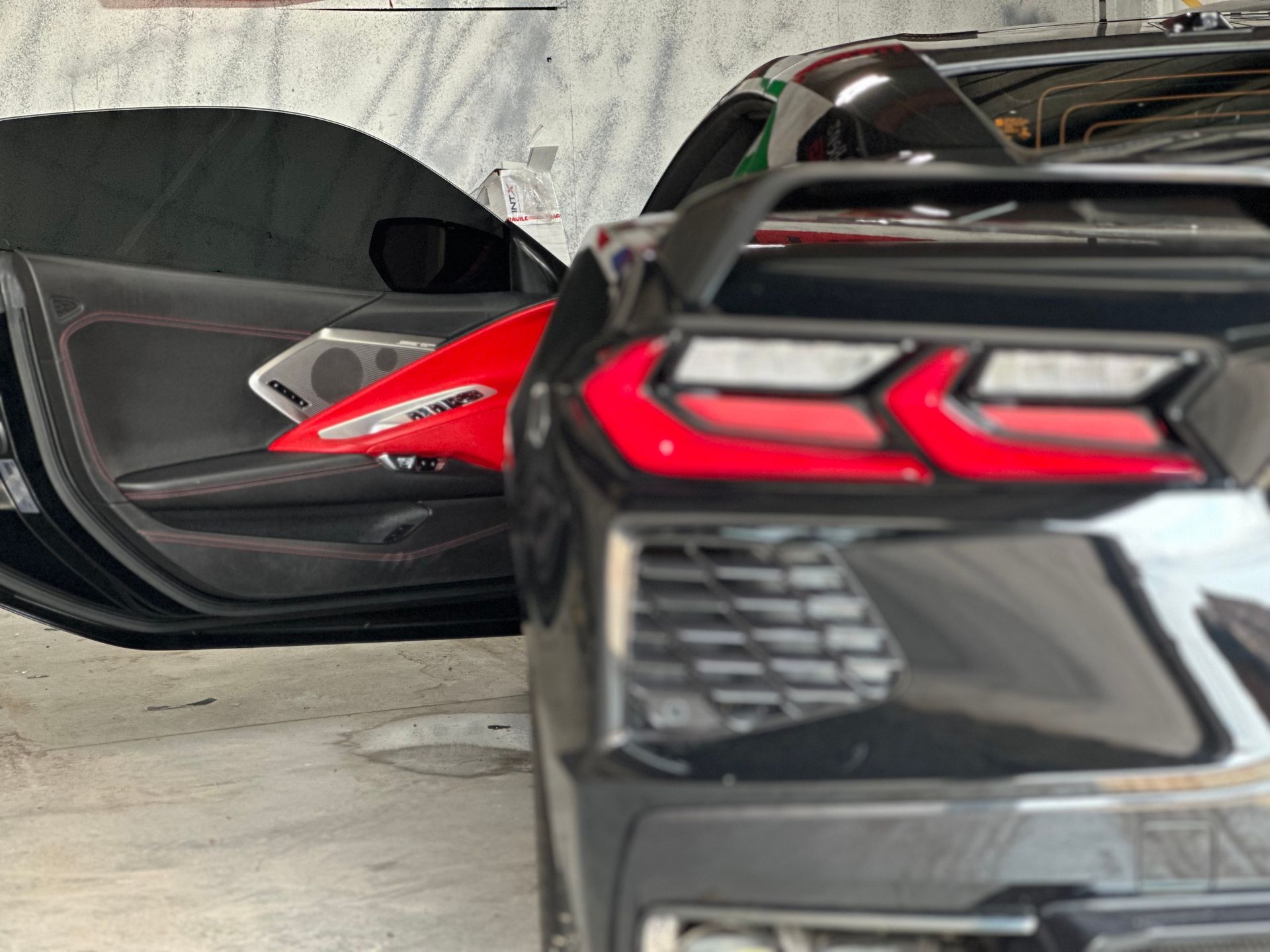 back of a black corvette with windows tinted