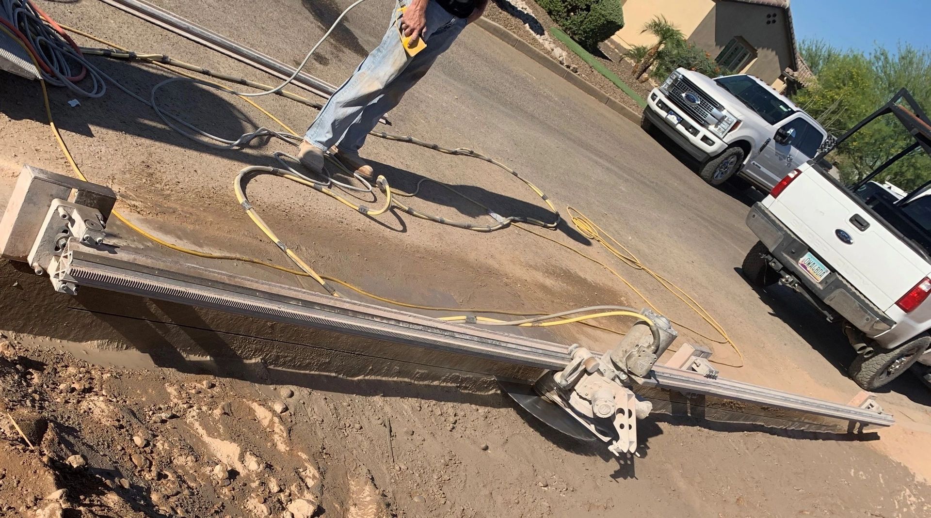 A man is standing next to a ladder on the side of a road.