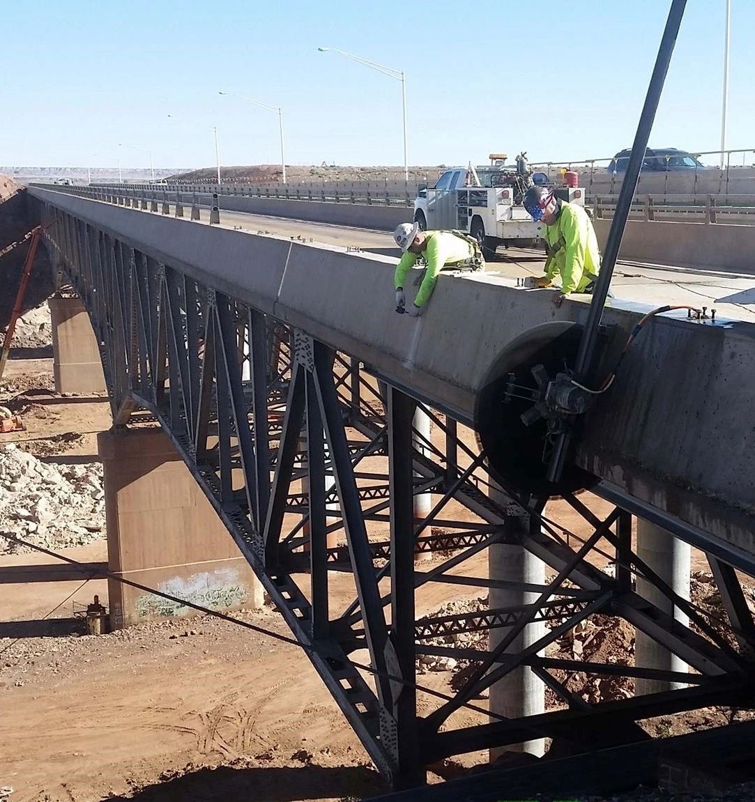 A group of construction workers are working on a bridge