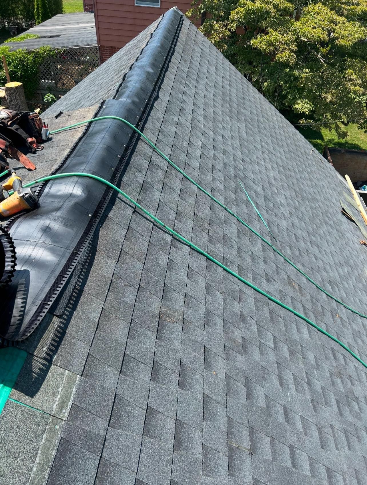 A roof with a green hose attached to it.
