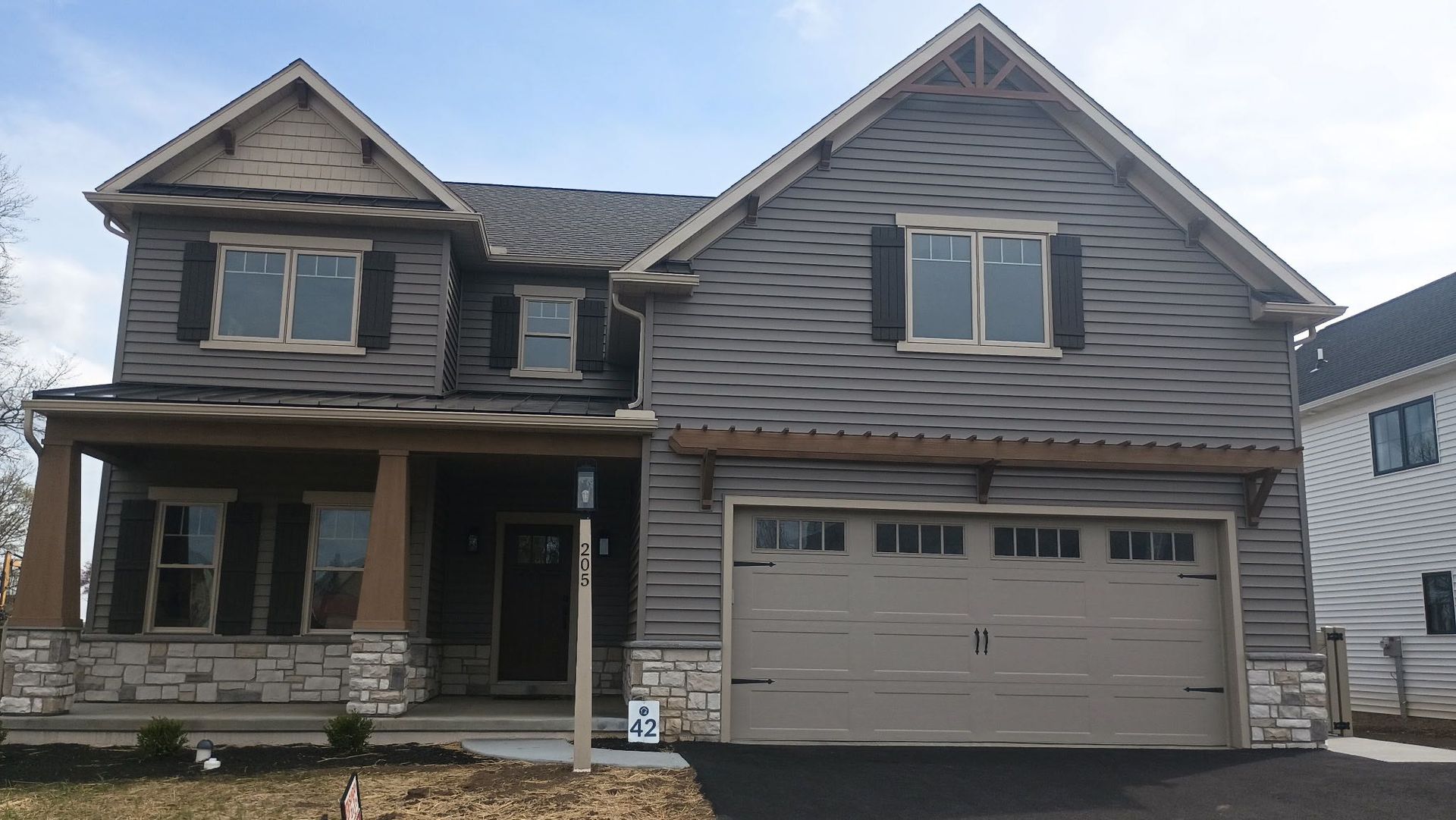A large house with a large garage and a porch