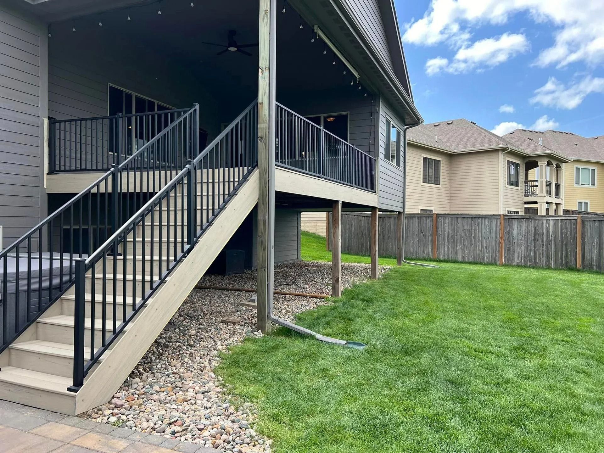A house with a deck and stairs leading up to it.