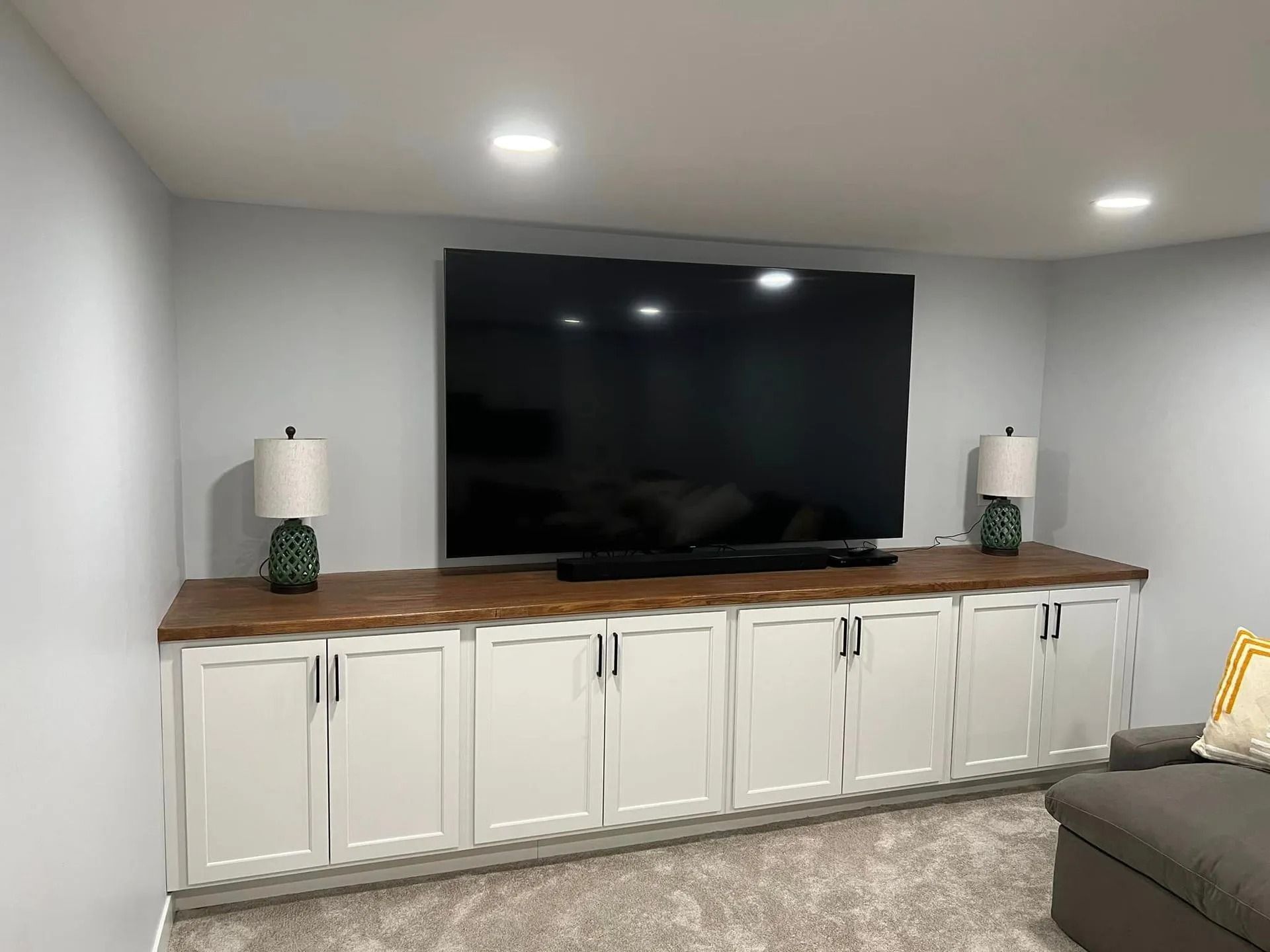 A living room with a large flat screen tv mounted to the wall.