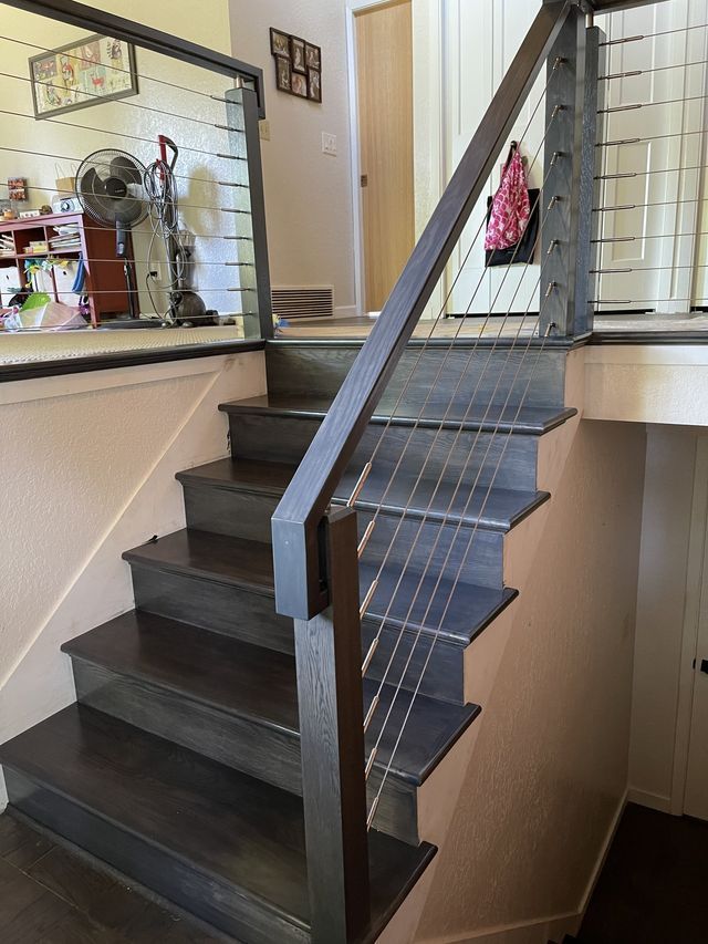 a wooden staircase with a metal railing in a house