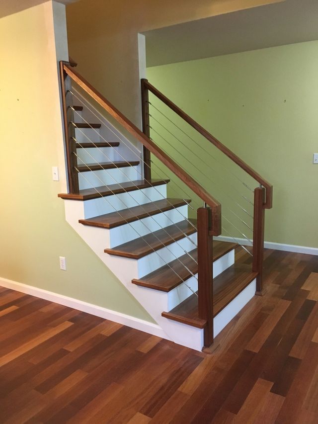 a staircase with wooden steps and a wire railing