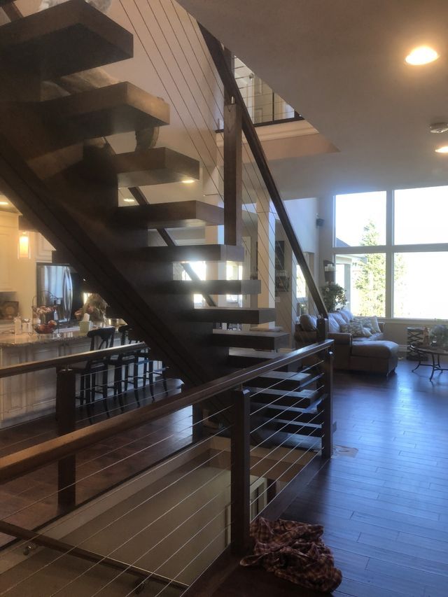 a staircase in a house with a glass railing