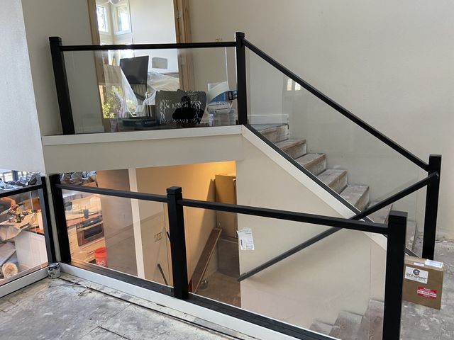 a staircase with a glass railing and a balcony .