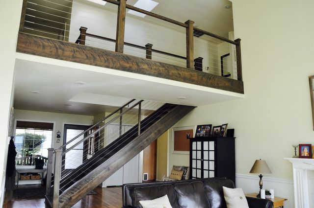 a living room with a staircase leading up to the second floor