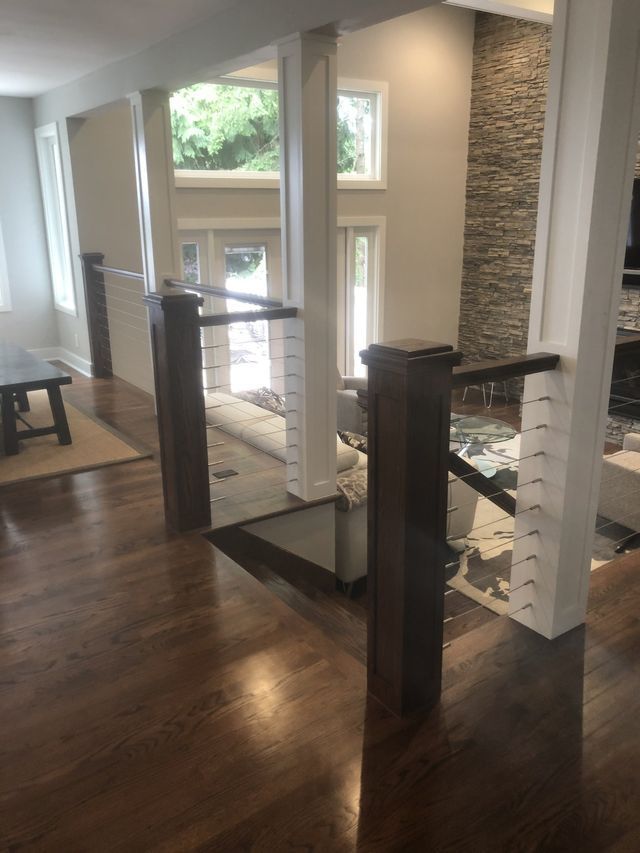a living room with hardwood floors and stairs leading up to the second floor .