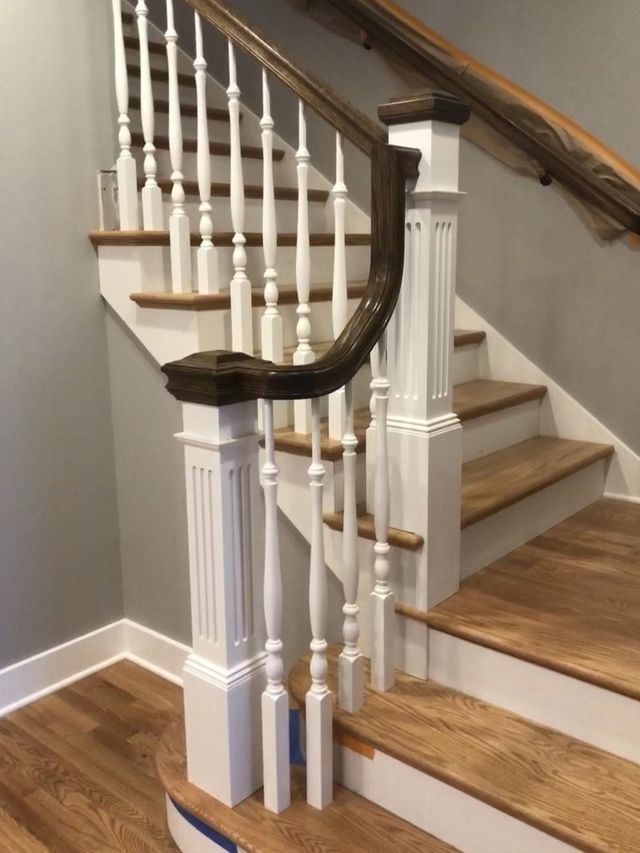 a staircase with white railings and wooden steps