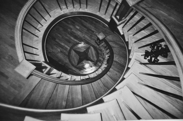 a black and white photo of a spiral staircase