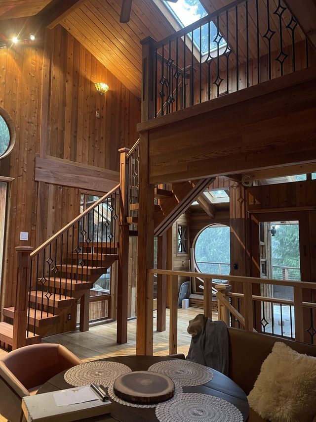 a living room with stairs leading up to the second floor