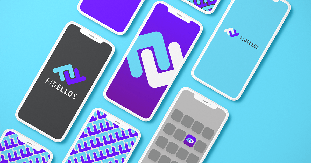 A bunch of phones are laying on top of each other on a blue surface.