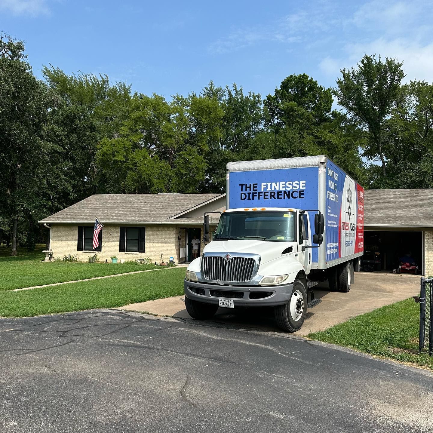 Moving truck parked in front of a house. 