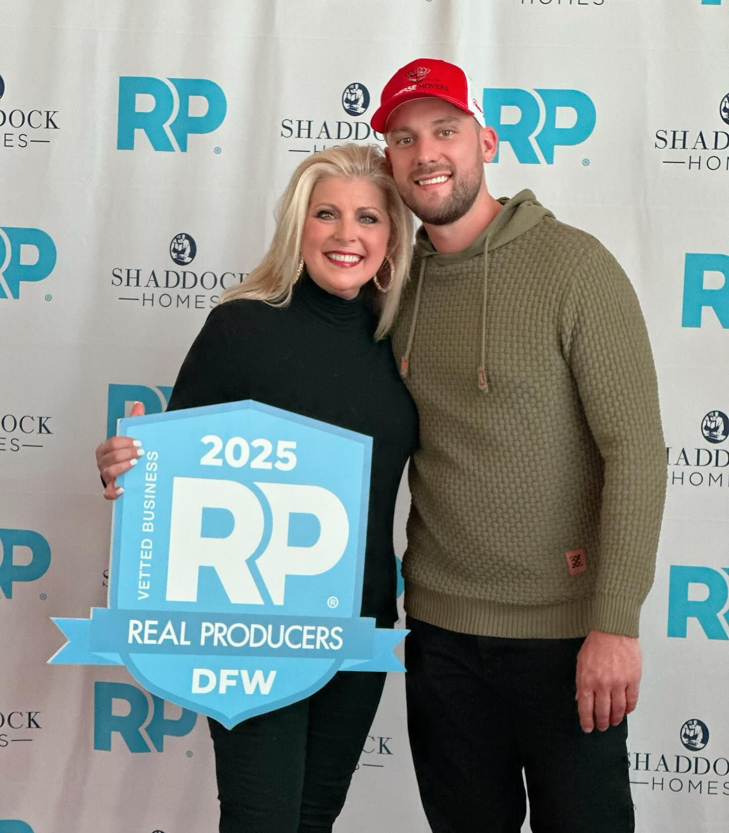 A woman and a man pose with a 