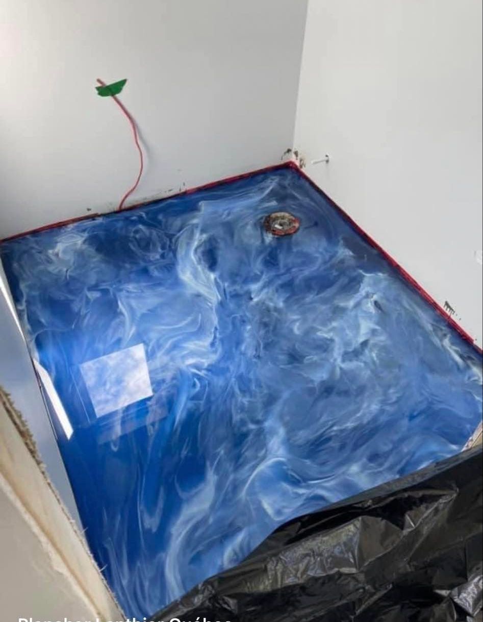 Un sol en marbre bleu et blanc dans une salle de bain.