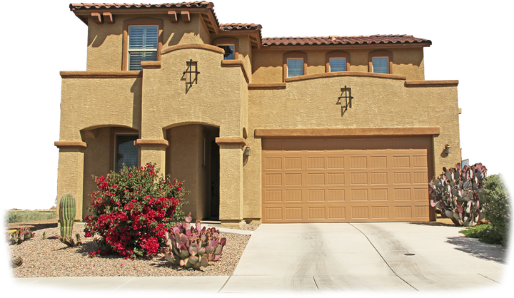 Tan stucco two-story home with a tan garage door, set in a desert landscape.