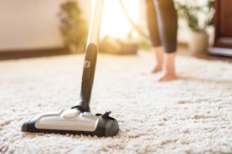 lady cleaning using the vacuum cleaner