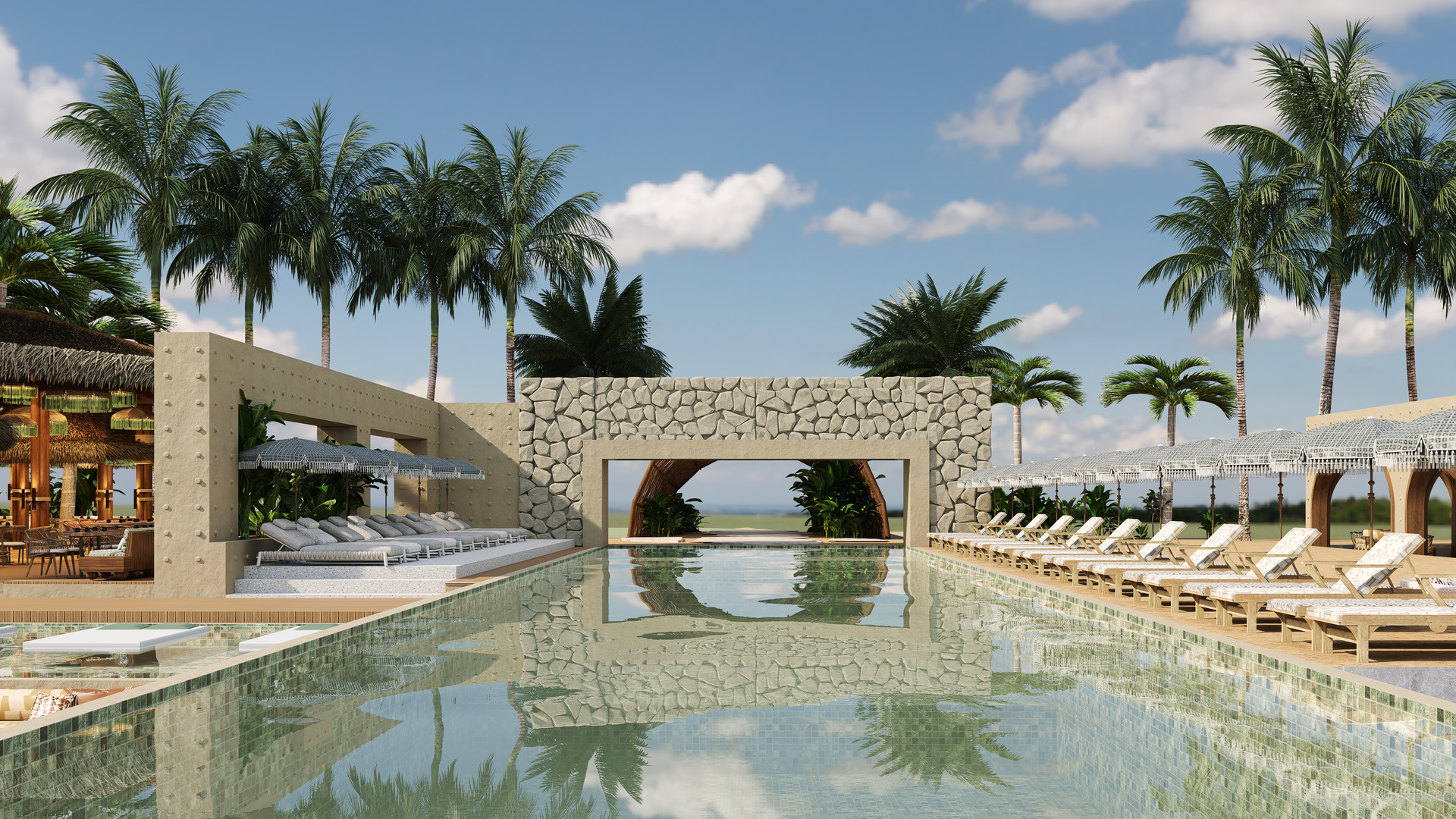 Swimming pool at a tropical resort with lounge chairs, palm trees, and a view of the ocean under a blue sky.