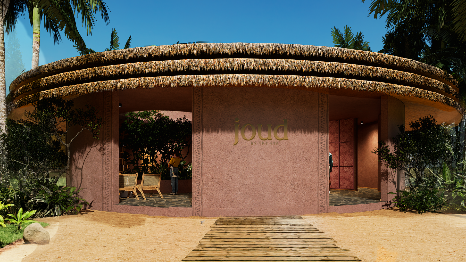 Circular building with thatched roof, pink stucco walls, and wooden walkway, in a tropical setting.