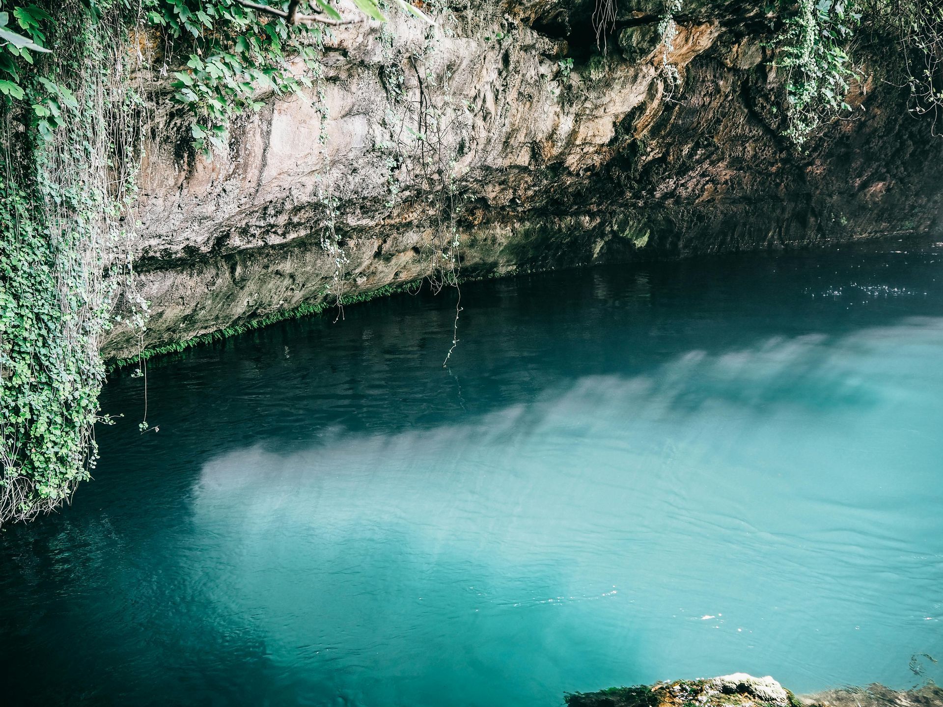 There is a large body of water in the middle of a cave.