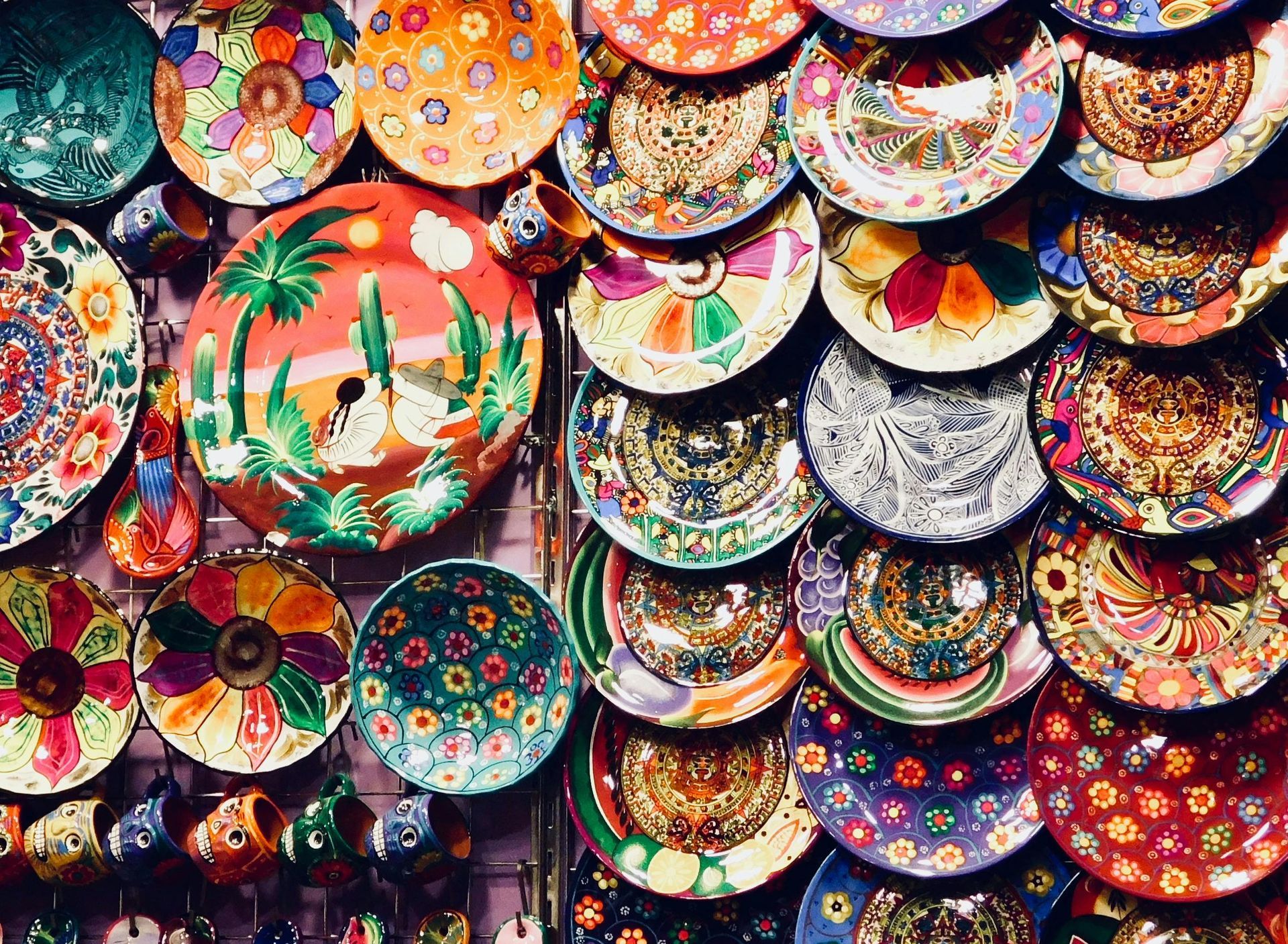 A bunch of colorful plates are stacked on top of each other on a wall.