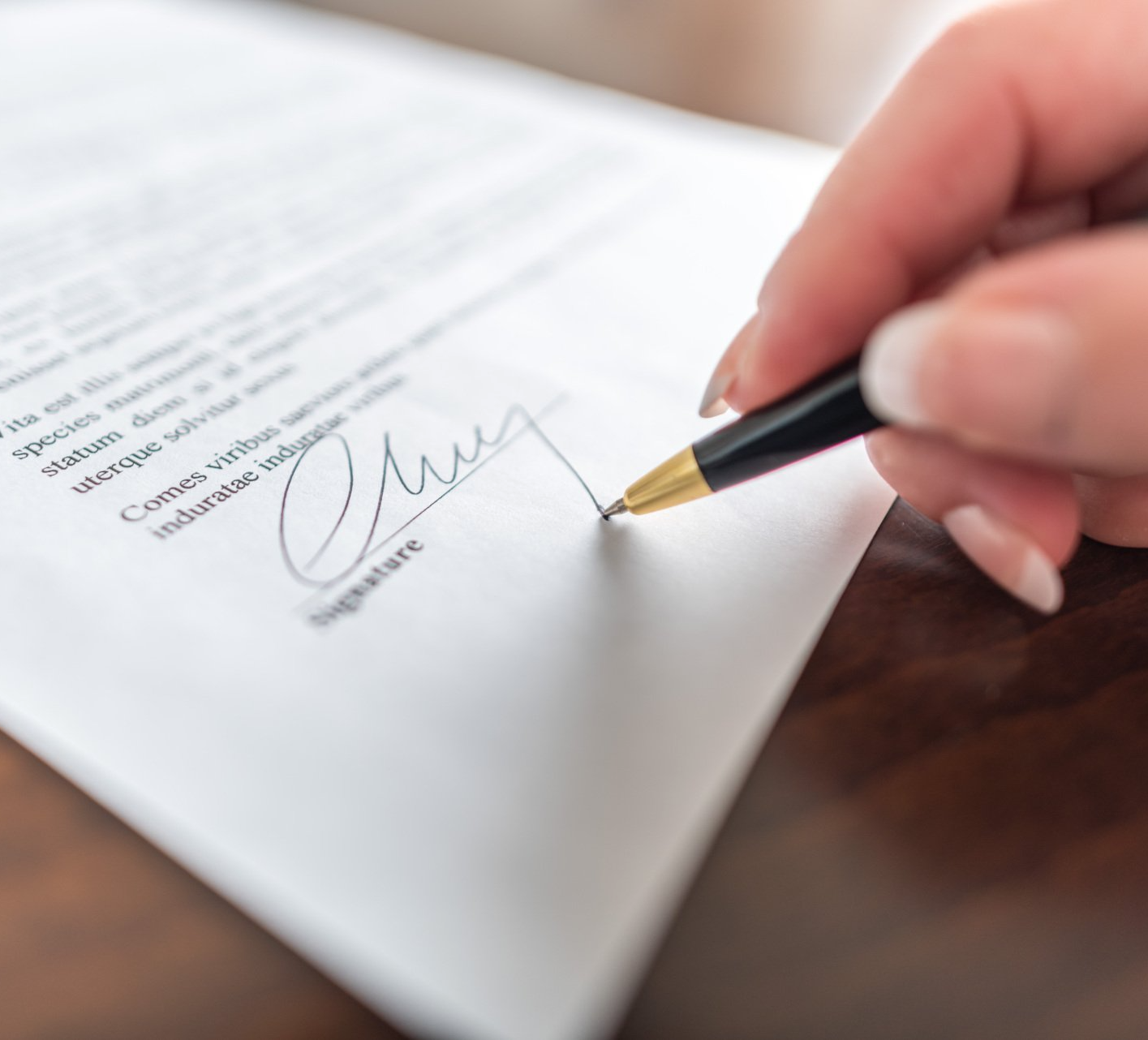 Woman hand signing a contract