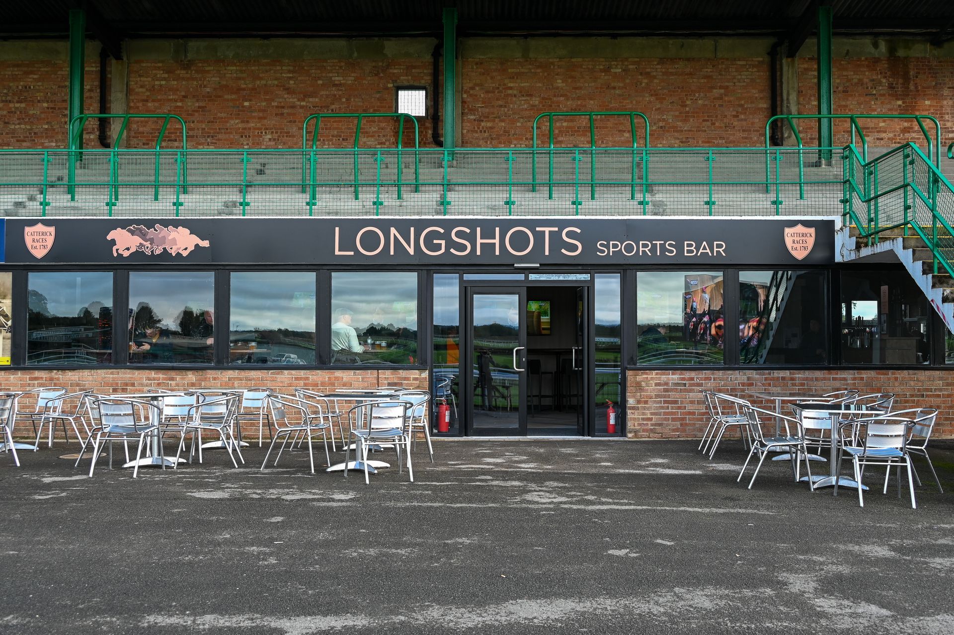 A restaurant called longshots with tables and chairs outside