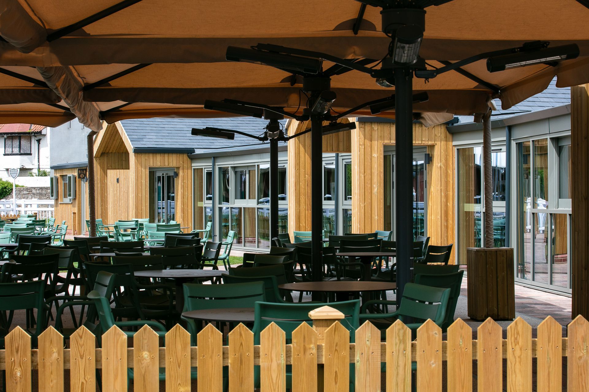 An artist 's impression of a restaurant with umbrellas and tables
