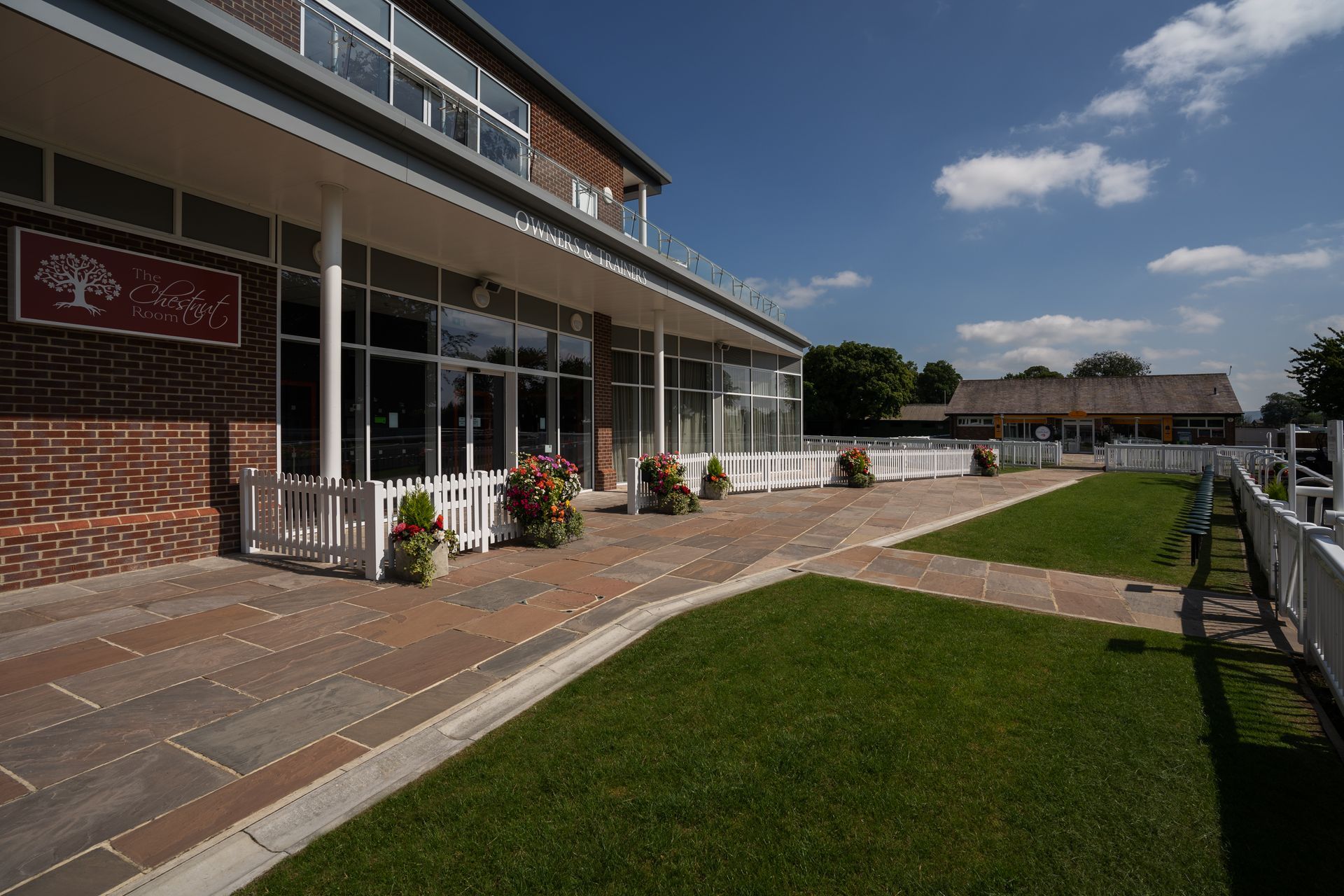 A large building with a large lawn in front of it.