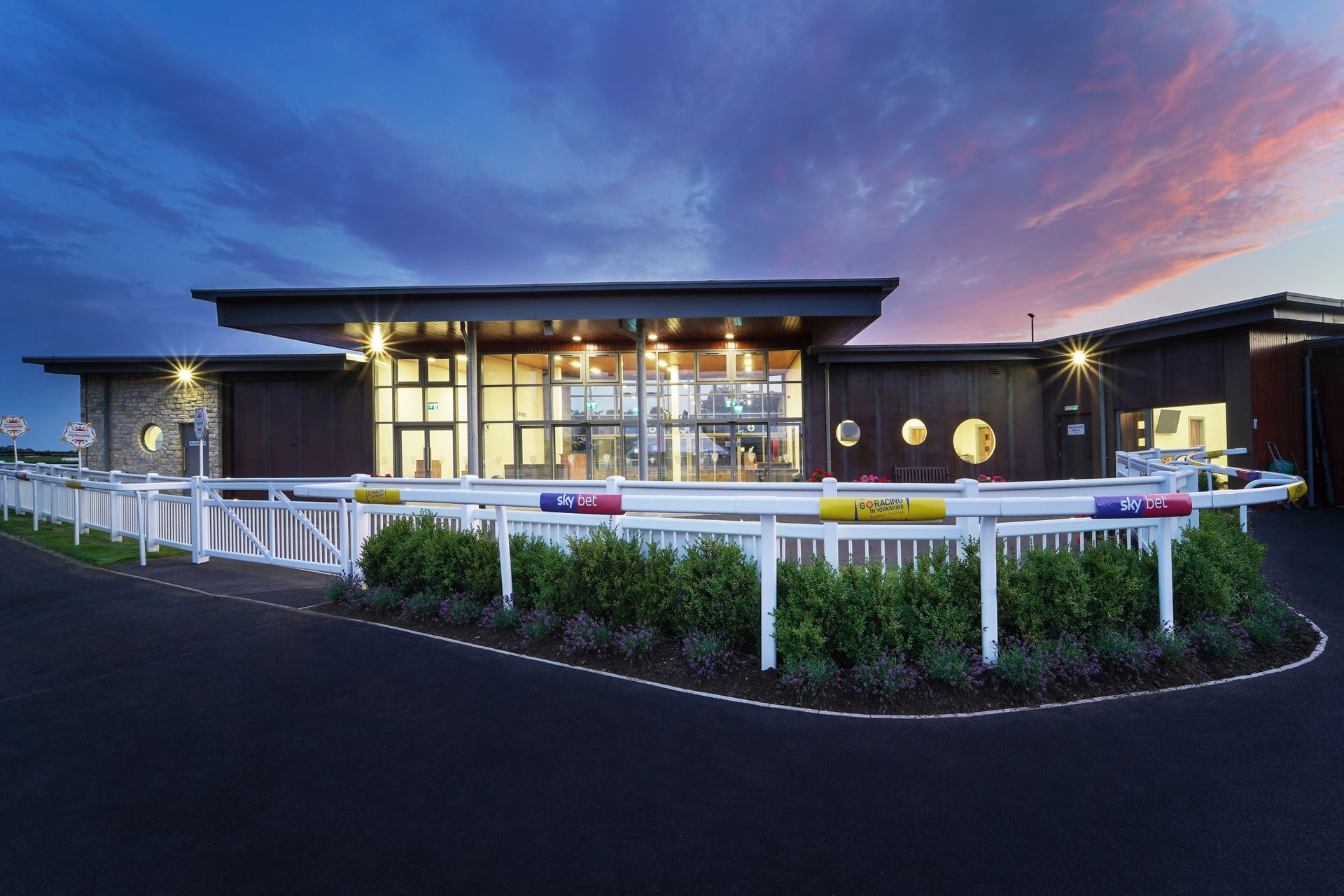 A large building with a fence in front of it.