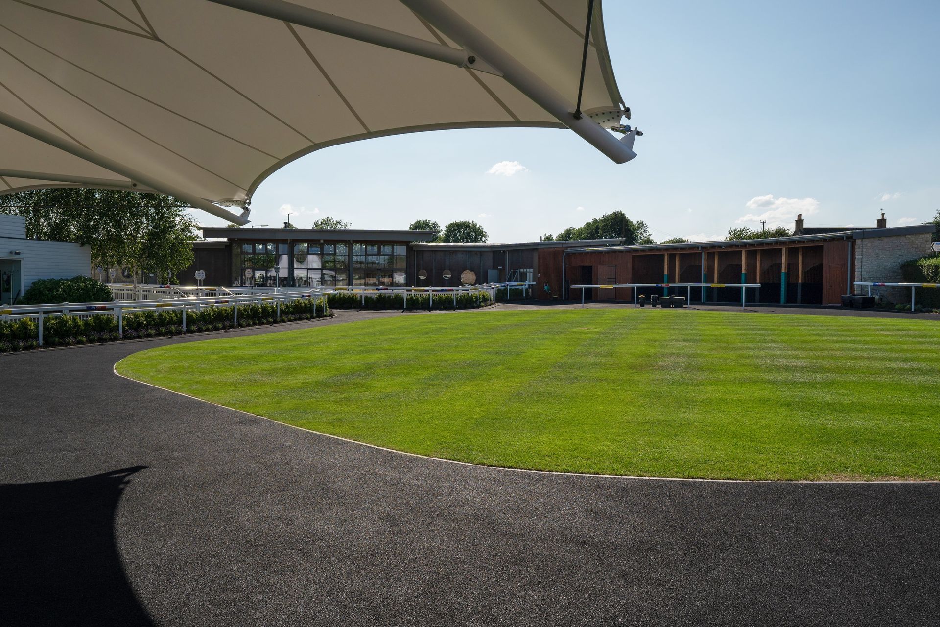 A large grassy field with a building in the background.