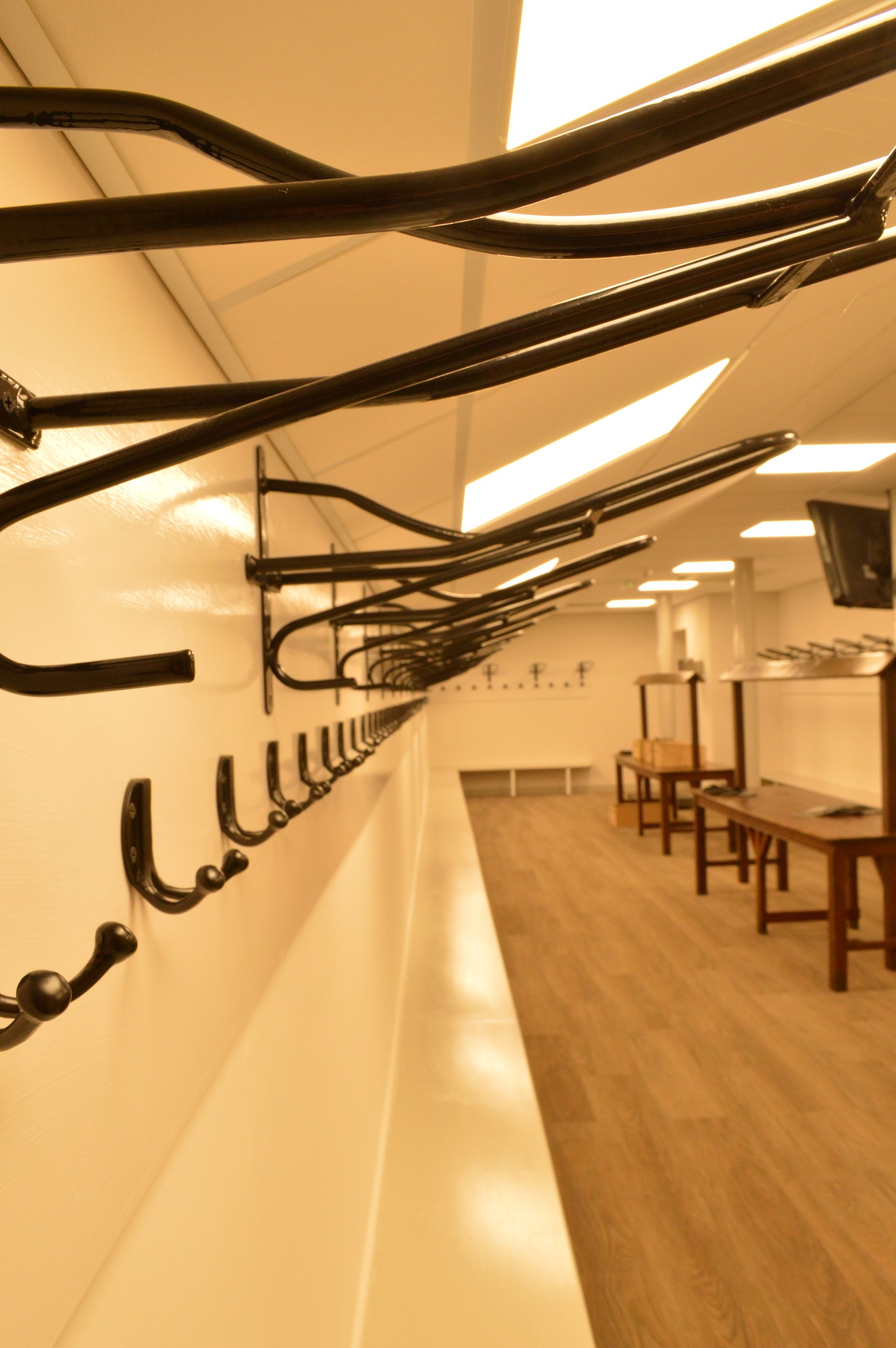 A row of hooks hanging on a wall in a locker room