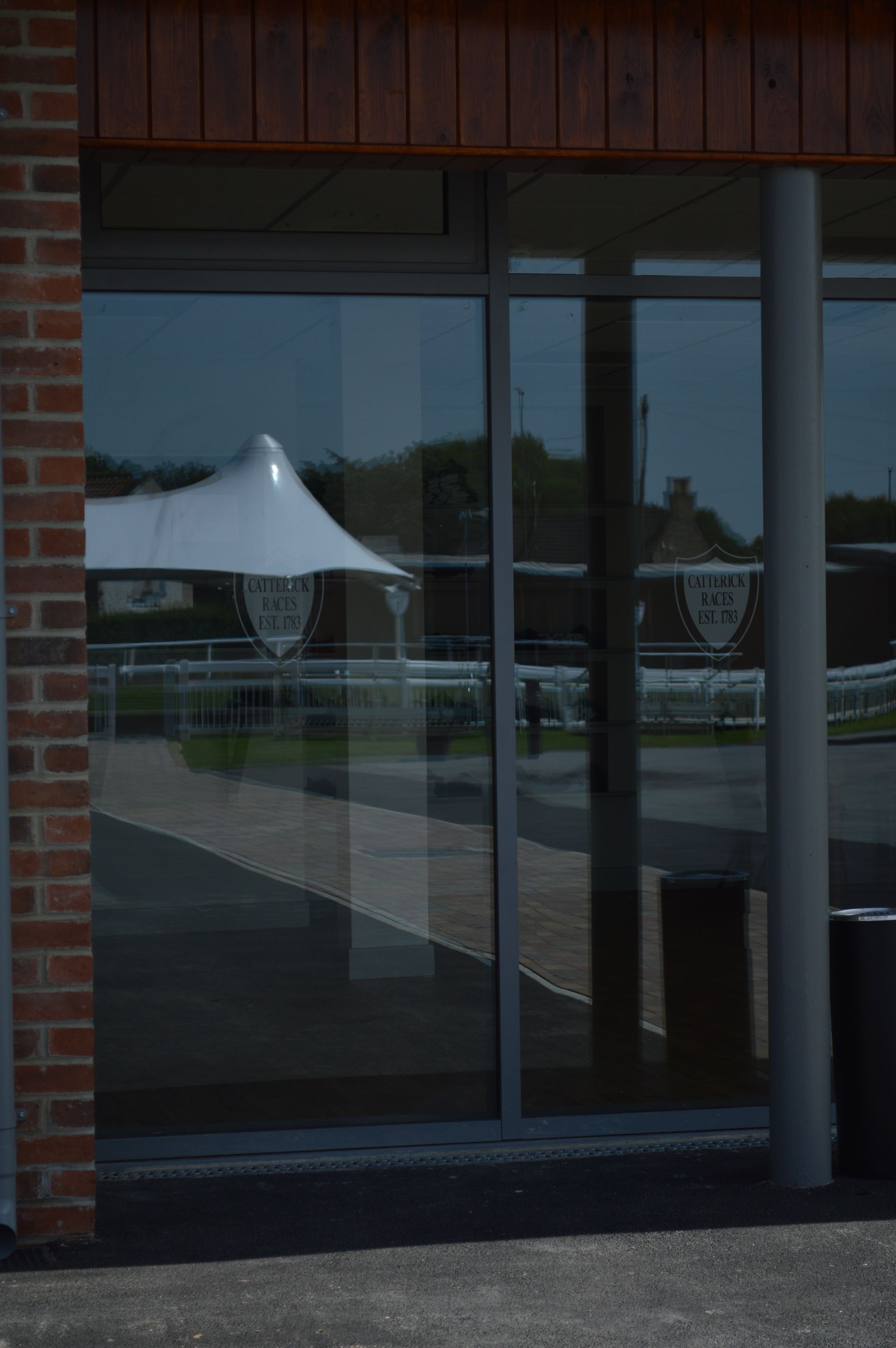 A reflection of a tent in a window of a building