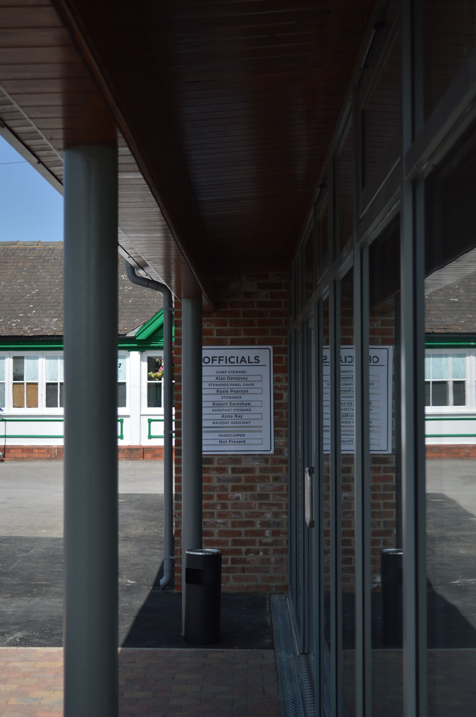 A brick building with a sign on the side of it.