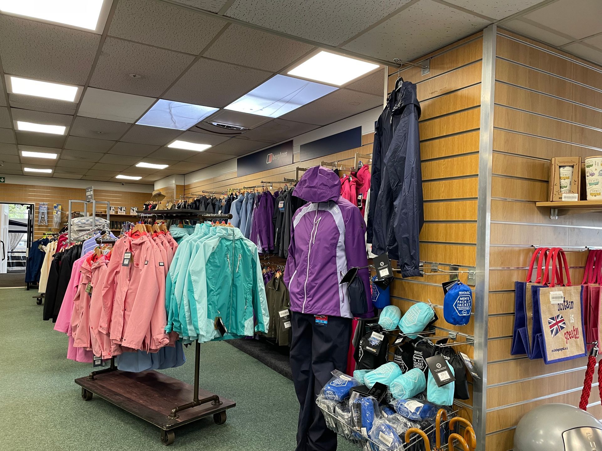 A store filled with lots of clothes and a mannequin.