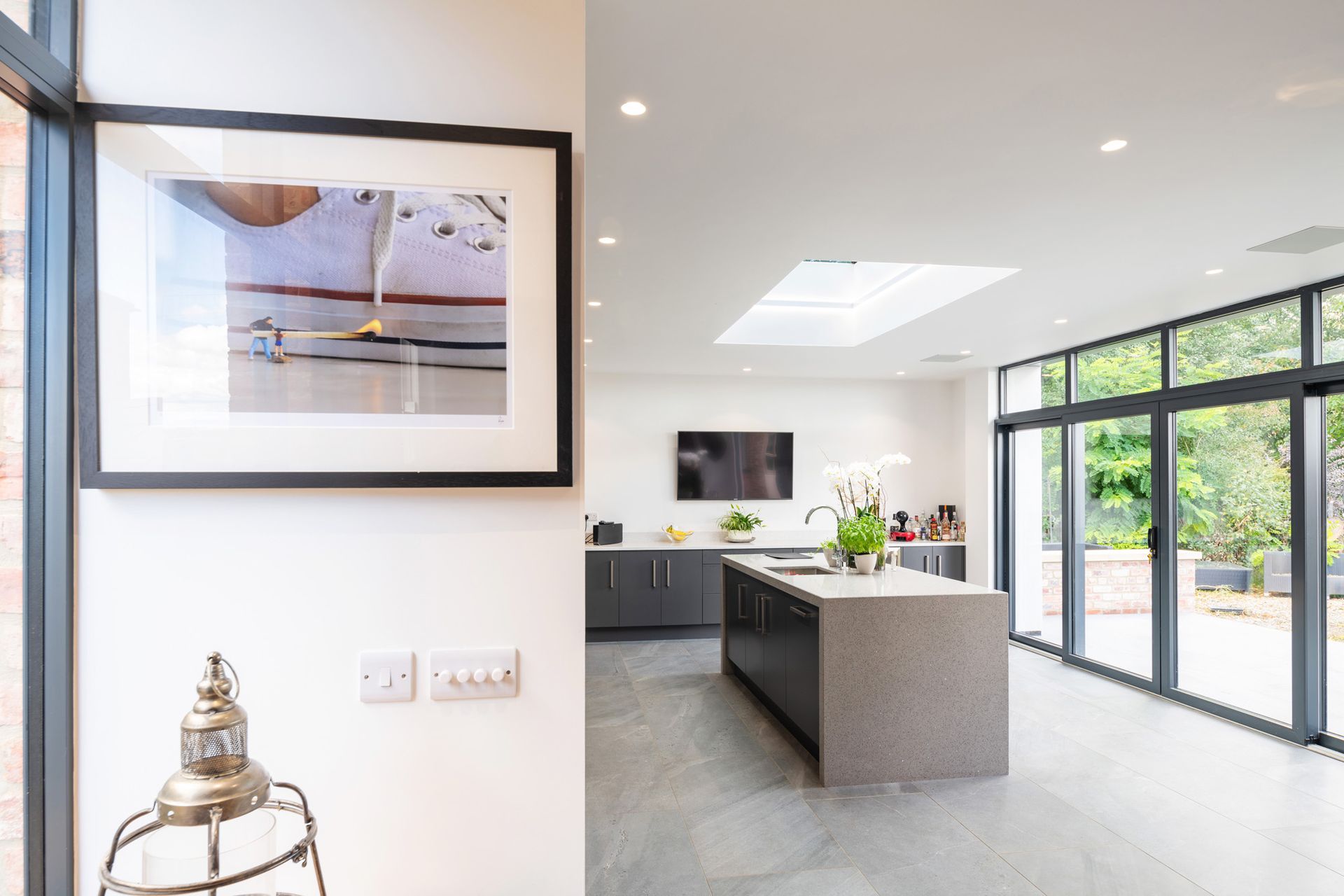 A kitchen with a large island and a picture on the wall above it.