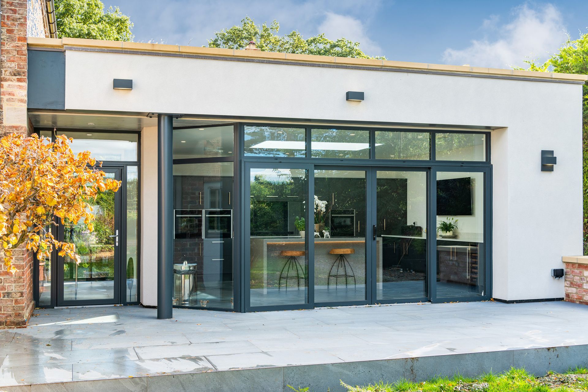 A house with a lot of windows and a patio