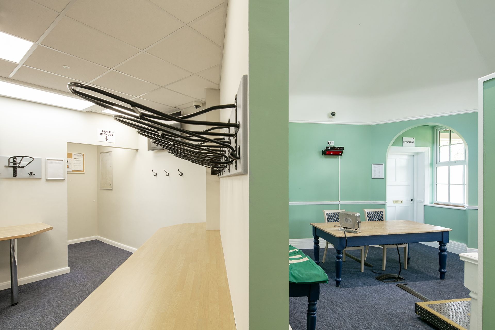 A room with green walls and a table and chairs