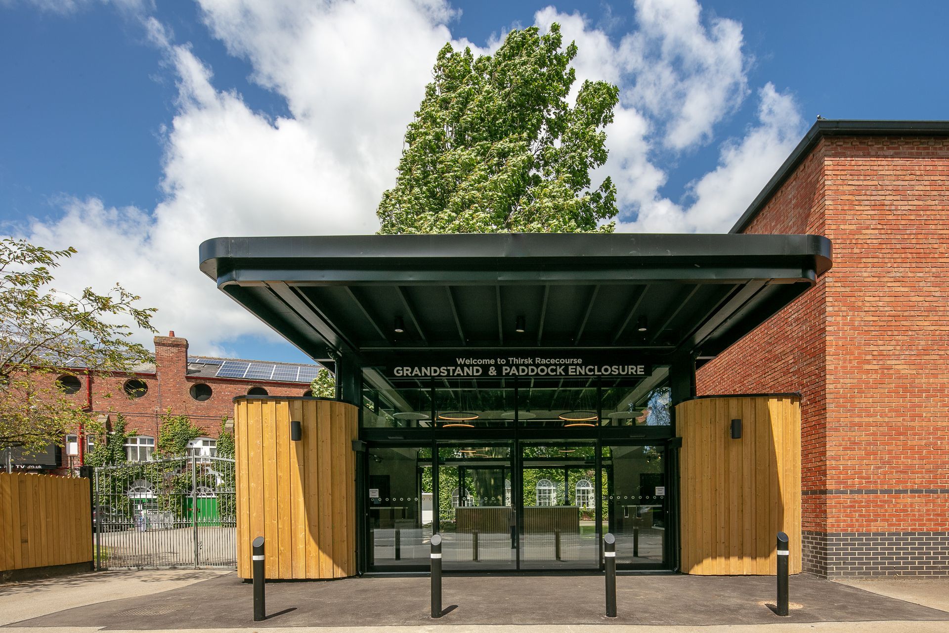 The entrance to a building with a tree in the background.