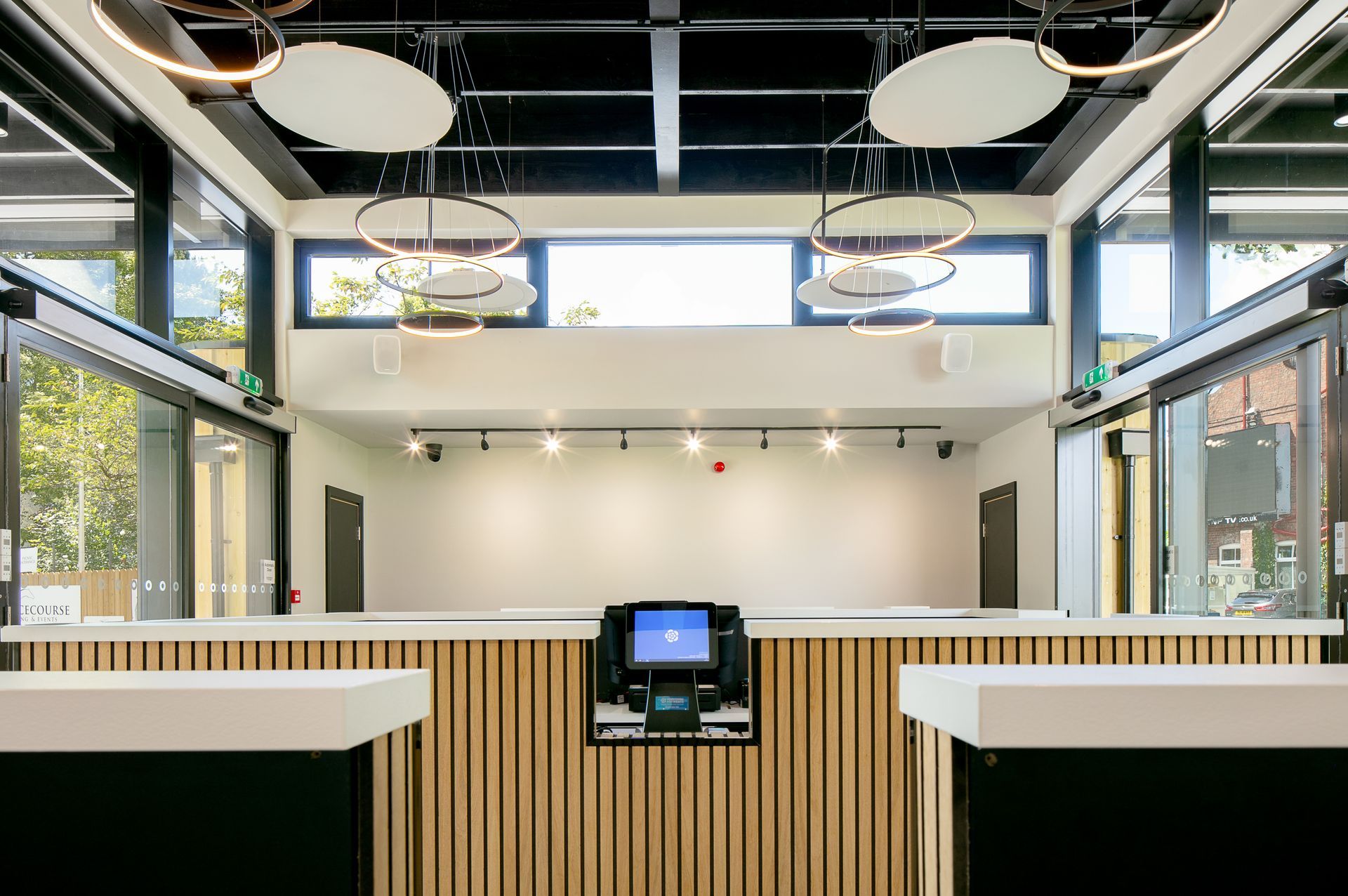 A large room with a wooden counter and a computer on it.