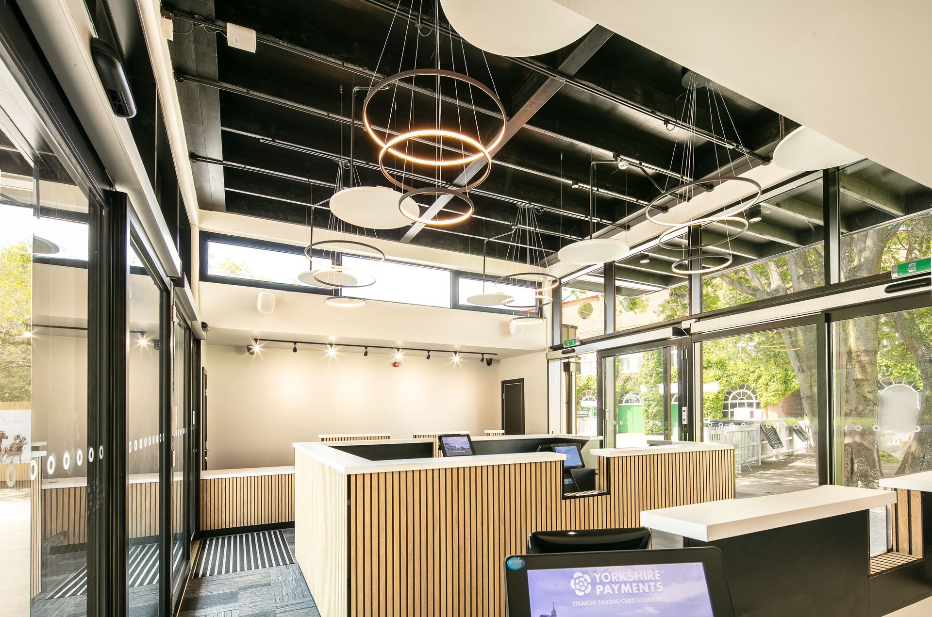 A large room with a lot of windows and a reception desk.