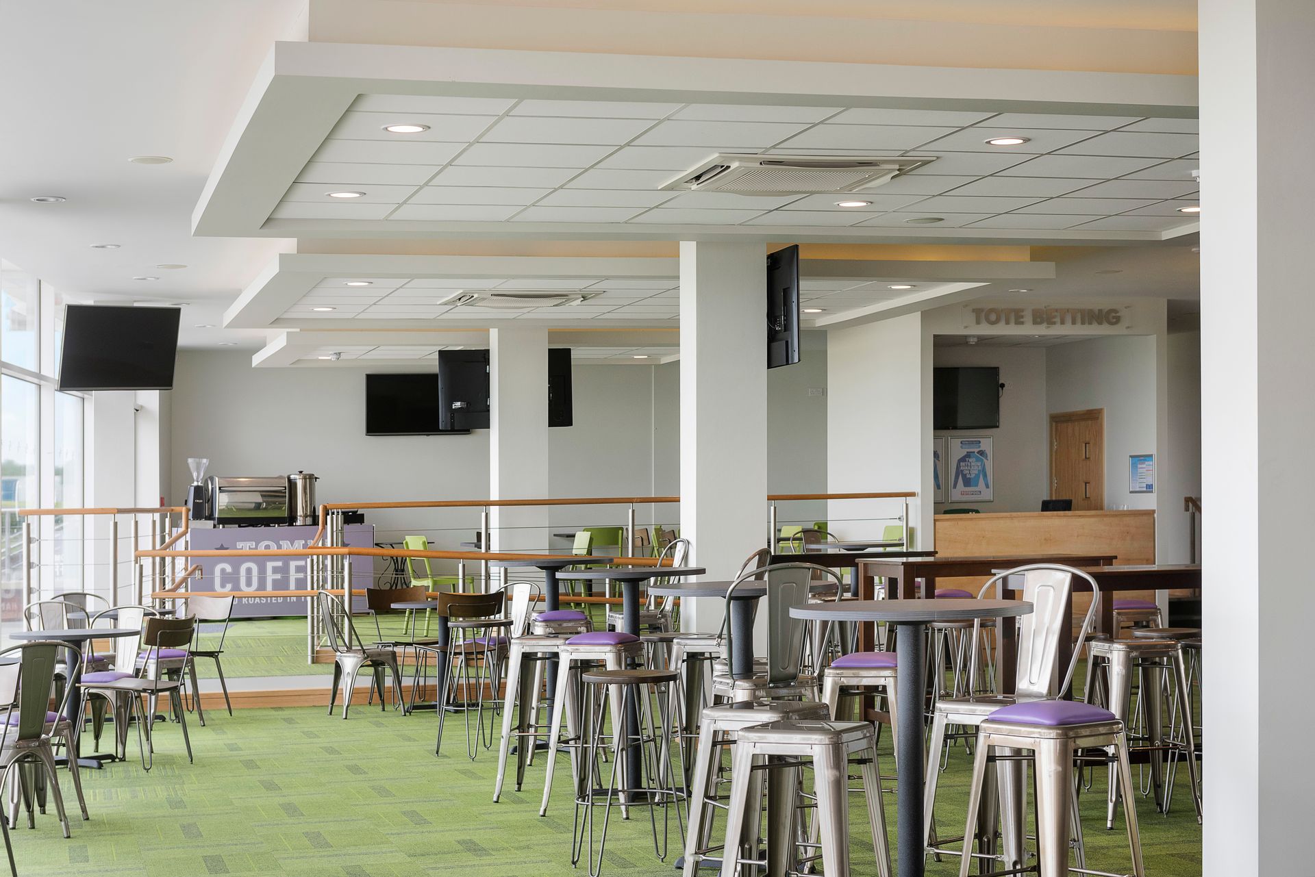 A large room filled with tables and chairs in a restaurant.