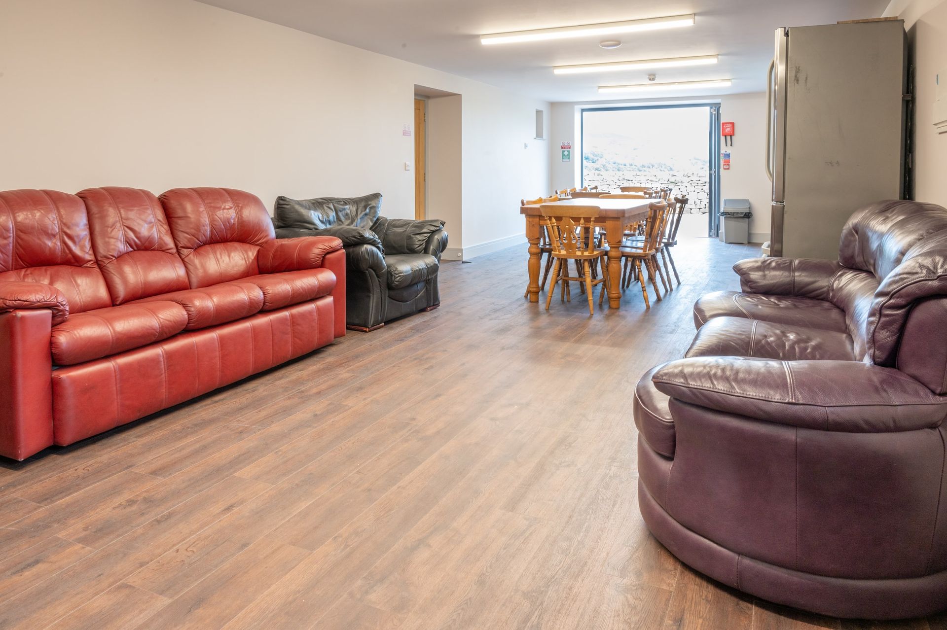 A living room with a couch , chairs , and a table.