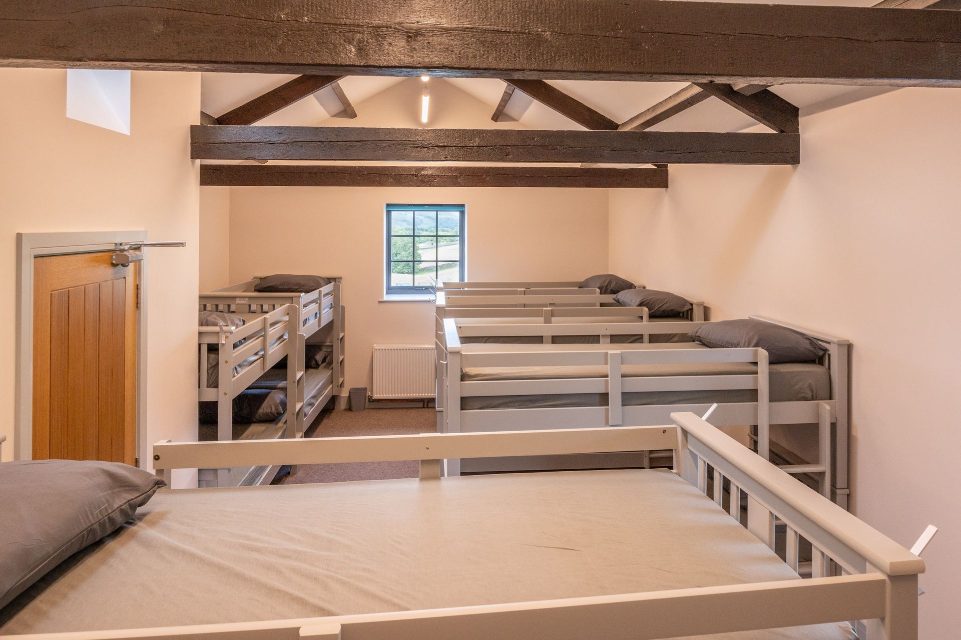A room filled with bunk beds and a window.