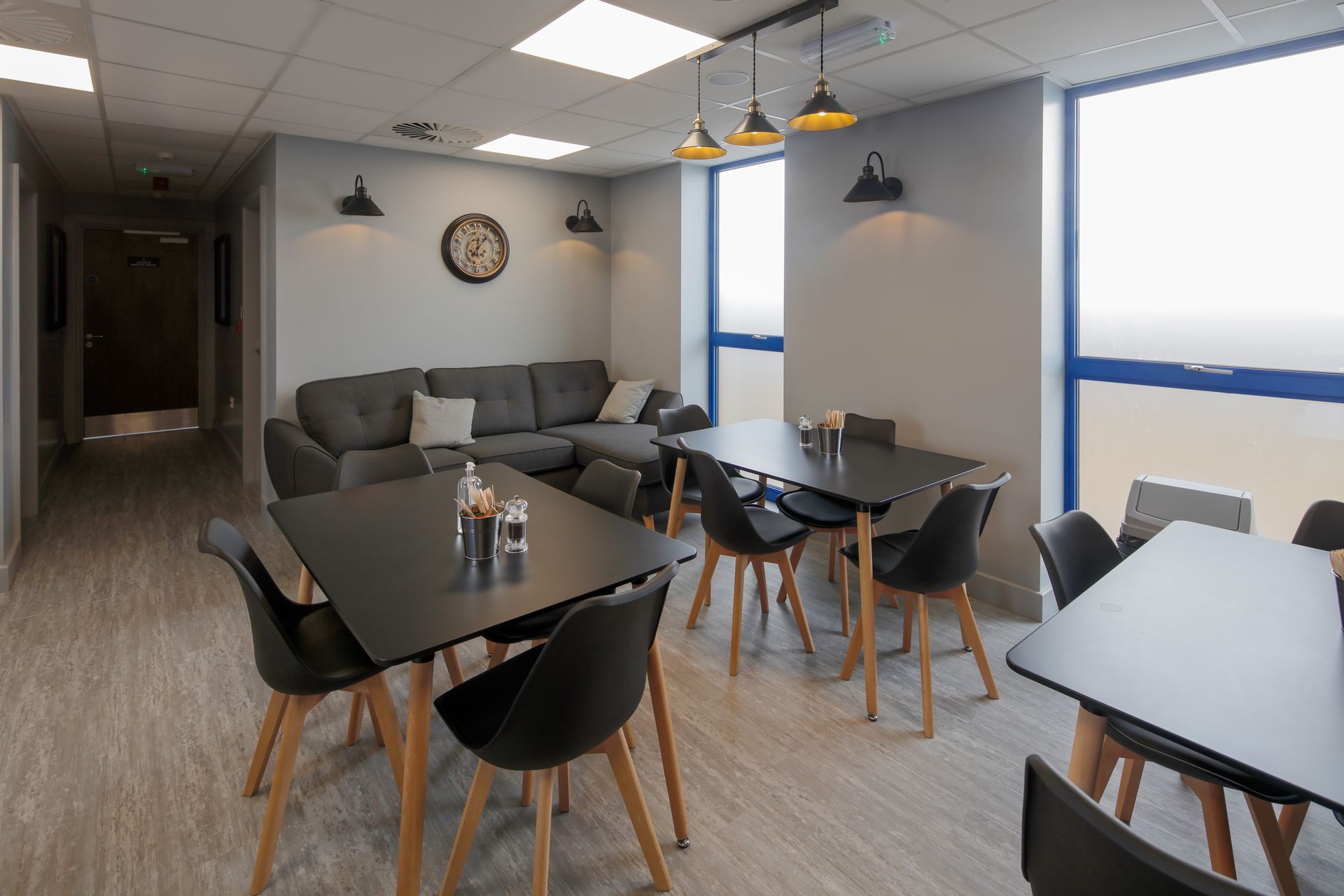 A living room with tables and chairs and a couch.