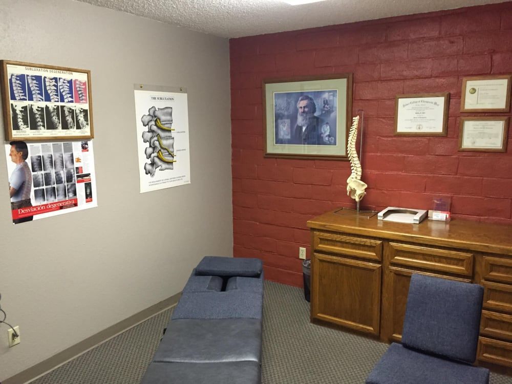 A room with a table and chairs and a red wall