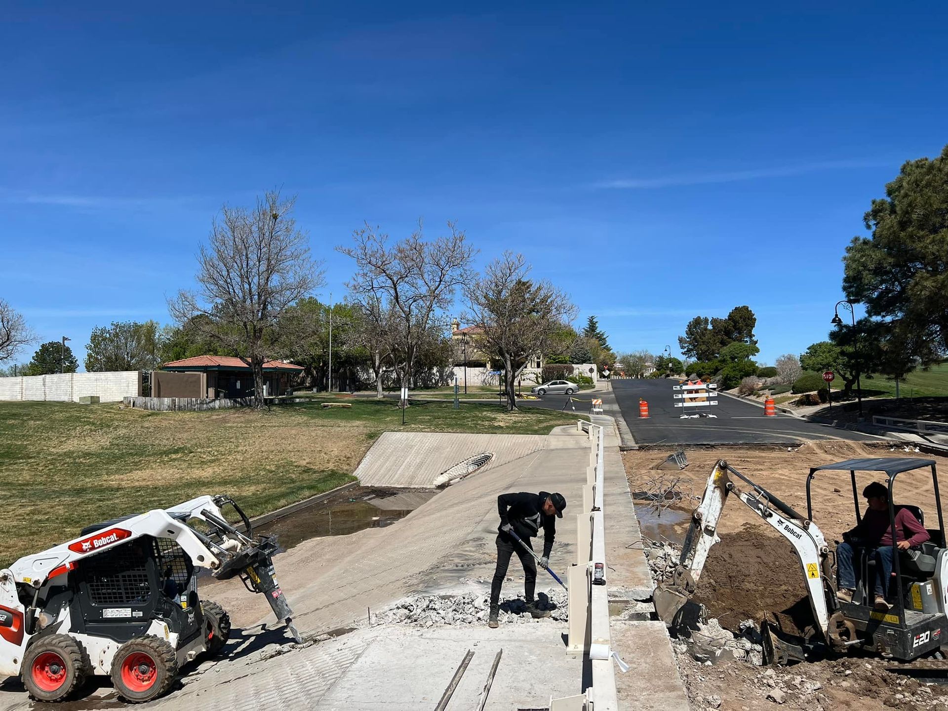 A group of construction workers are working on a road.